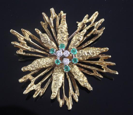 A 1970s 18ct gold, emerald and diamond set stylised starburst brooch, 5.5cm.